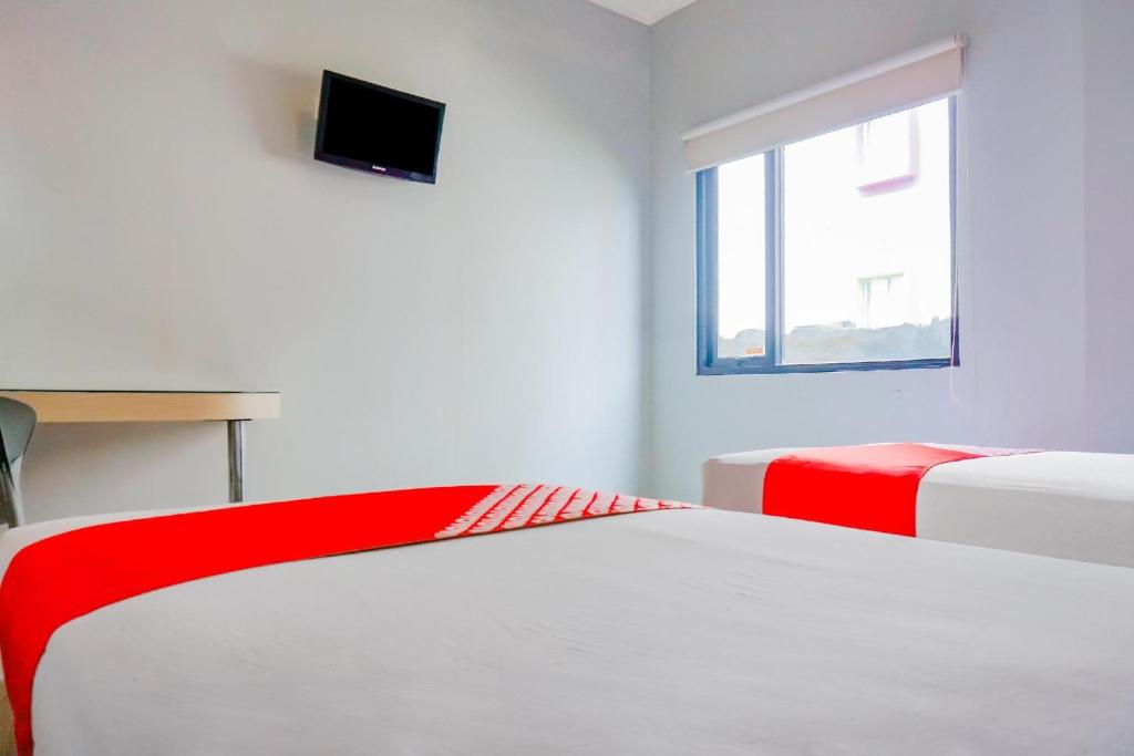 Postel nebo postele na pokoji v ubytování Collection O Hotel Antara