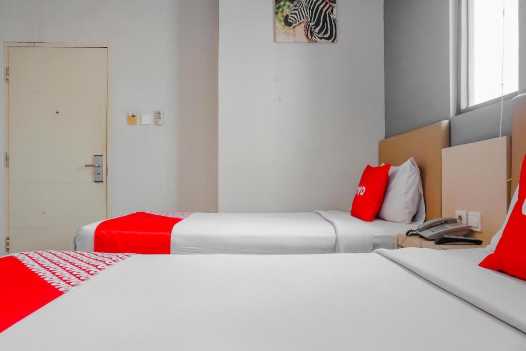 Postel nebo postele na pokoji v ubytování Collection O Hotel Antara