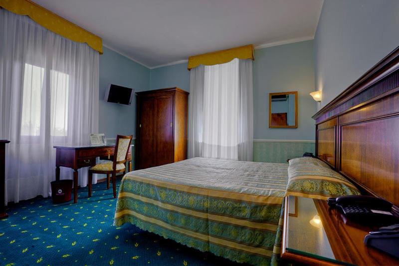 Postel nebo postele na pokoji v ubytování Hotel Castello