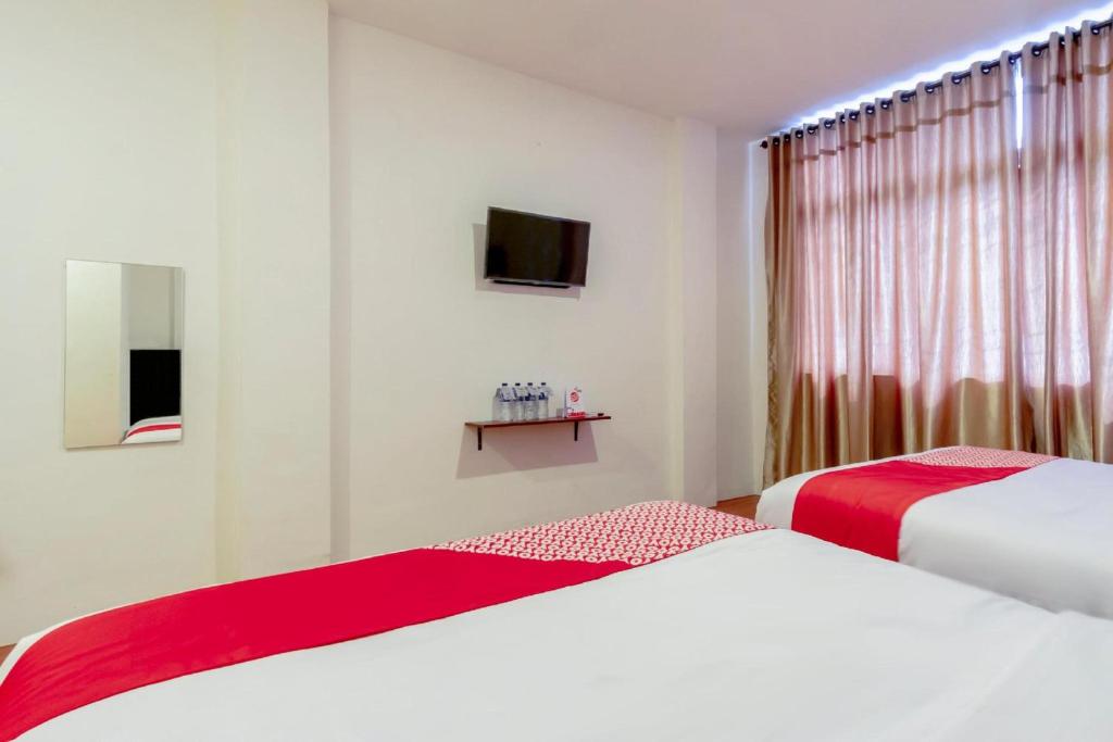 Postel nebo postele na pokoji v ubytování Collection O Medan City Near Rsud Dr Pirngadi Formerly Tmj Guest House
