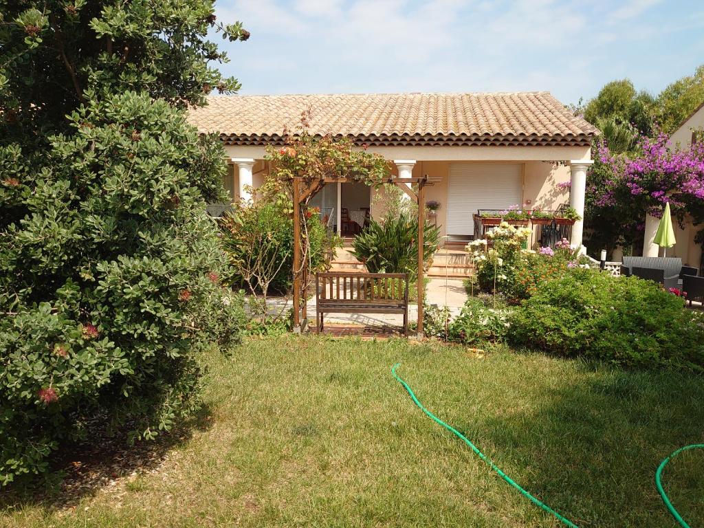 a house with a garden with a hose in the yard at L'orangerai d'Antibes in Antibes