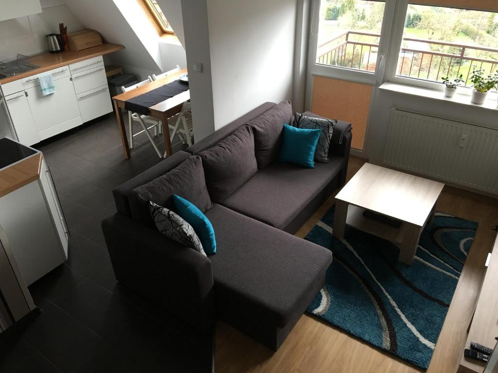a living room with a couch and a table at Apartament Slupsk in Słupsk