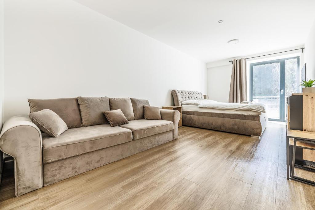 a living room with a couch and a table at Jasmínový Ráj in Vítkovice