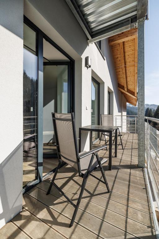 a patio with a table and chairs on a balcony at Jasmínový Ráj in Vítkovice