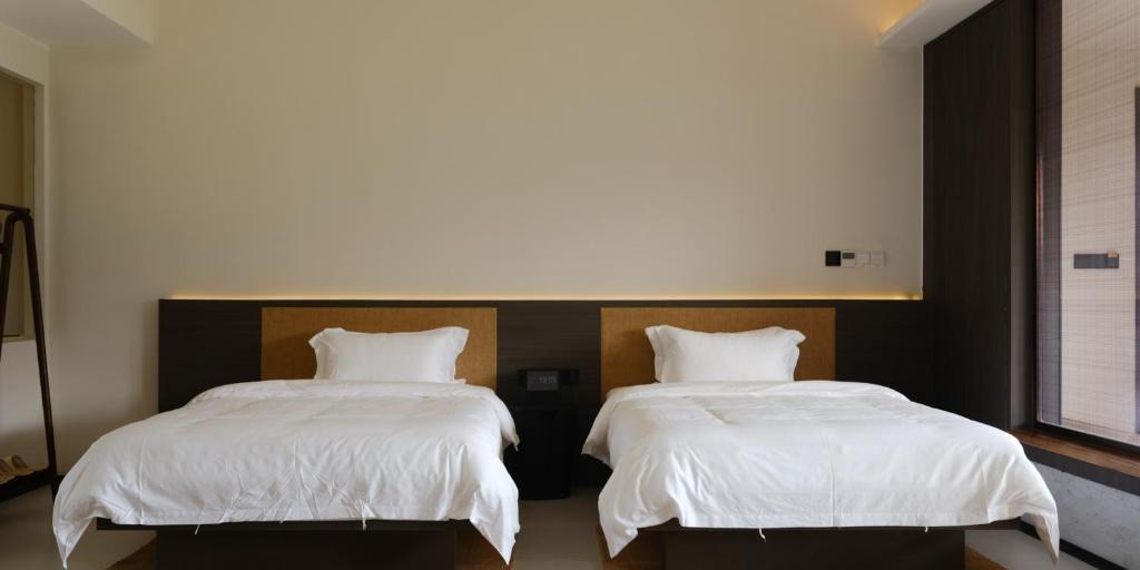Postel nebo postele na pokoji v ubytování Huangshan Yixian Pumanmanju Hotel