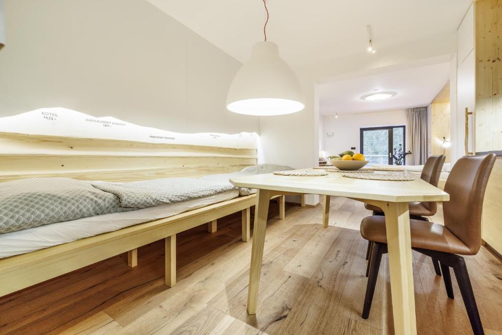 a bedroom with a bed and a table and chairs at Jasmínový Ráj in Vítkovice