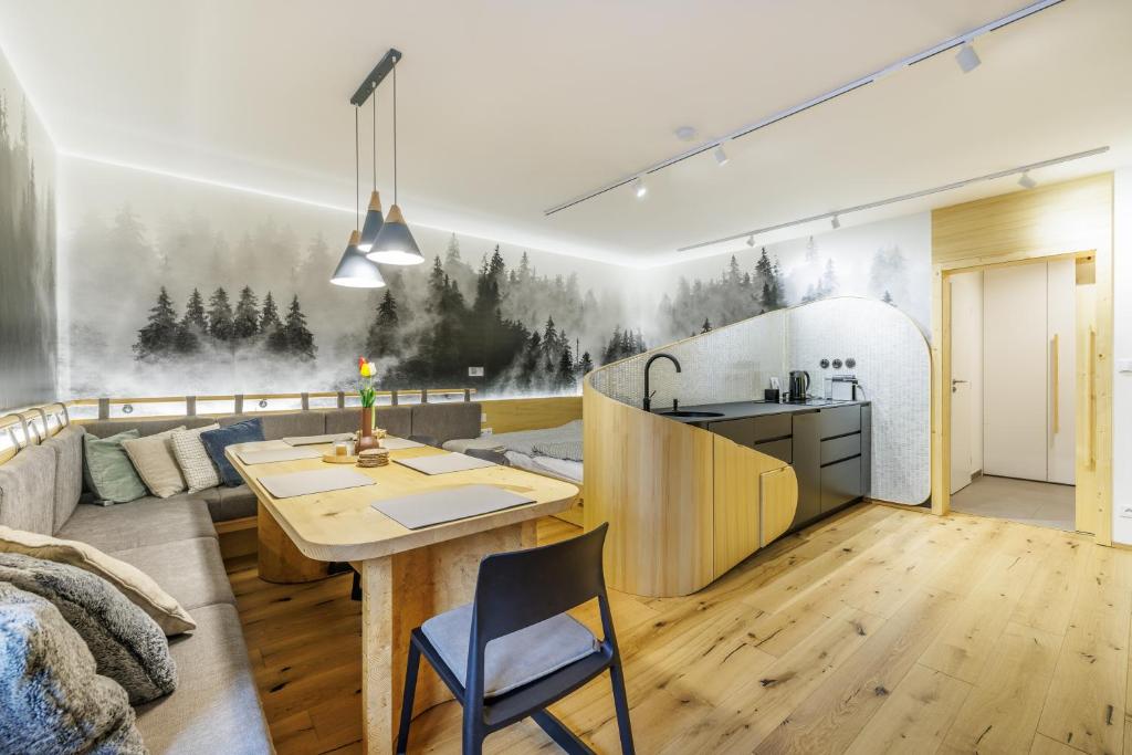 a kitchen and living room with a couch and a table at Jasmínový Ráj in Vítkovice