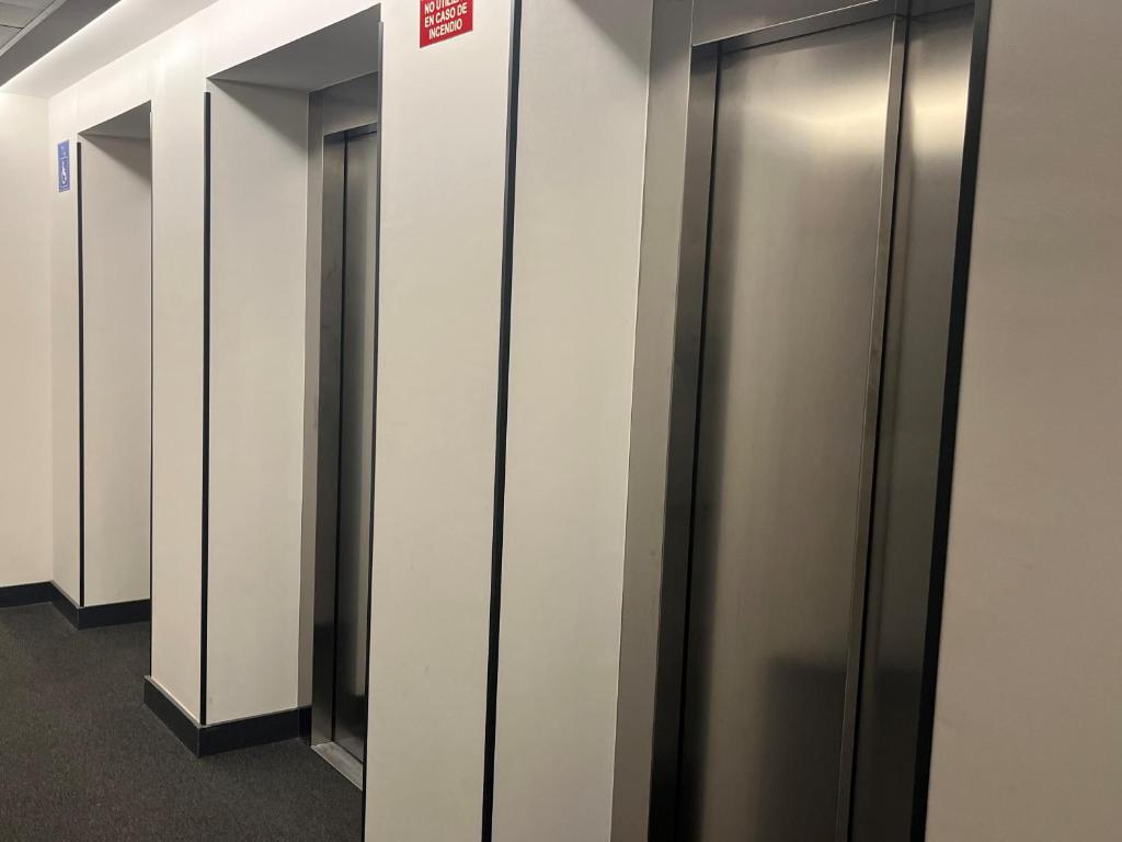 a row of elevator stalls in a building at Hs Madrid Centro Atocha in Madrid
