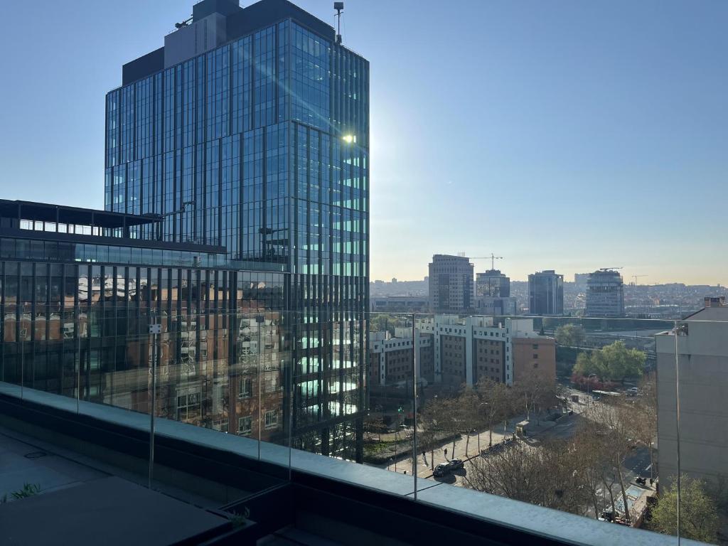 a view of a tall glass building in a city at Hs Madrid Centro Atocha in Madrid