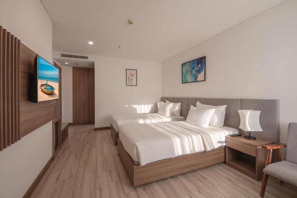 Giường trong phòng chung tại Gosia Hotel