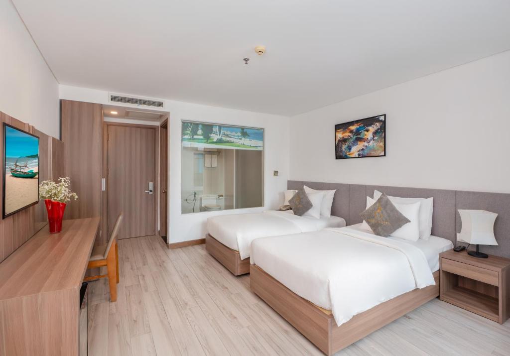 Giường trong phòng chung tại Gosia Hotel
