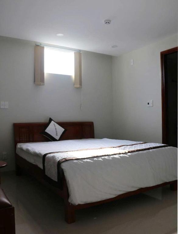 Postel nebo postele na pokoji v ubytování Huy Hoàng Hotel Đà Nẵng
