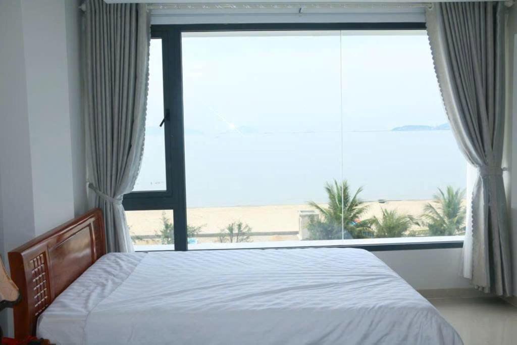 Postel nebo postele na pokoji v ubytování Huy Hoàng Hotel Đà Nẵng