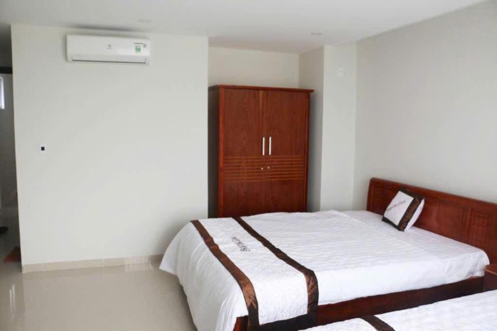 Postel nebo postele na pokoji v ubytování Huy Hoàng Hotel Đà Nẵng