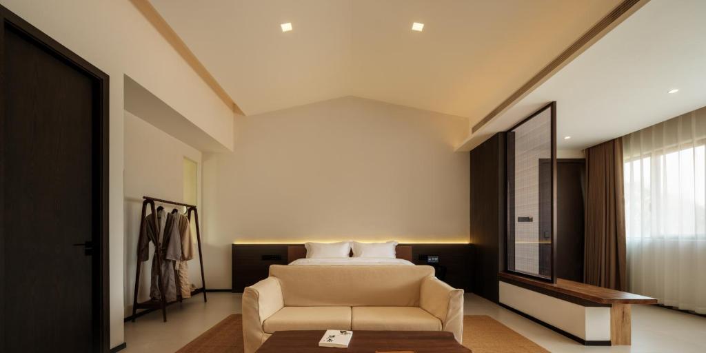 Postel nebo postele na pokoji v ubytování Huangshan Yixian Pumanmanju Hotel