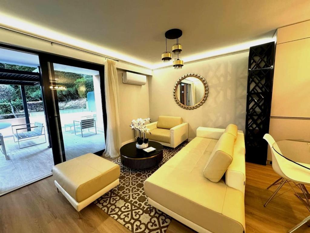 un salon avec un canapé et une table dans l'établissement Stylish flat 1BR with terrace, park & pool, à Roquebrune-Cap-Martin