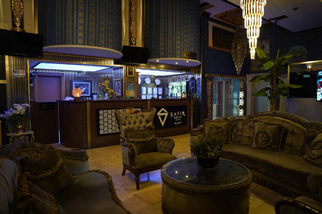 a living room with a couch and chairs and a table at Safir Hotels Silivri in Silivri