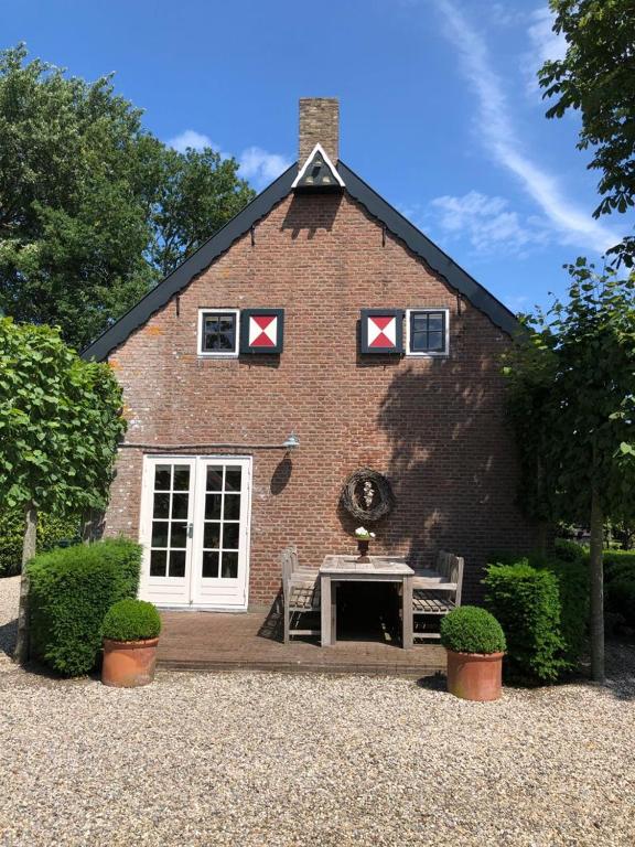 a brick building with a table in front of it at Huize Oostduin in Oostkapelle