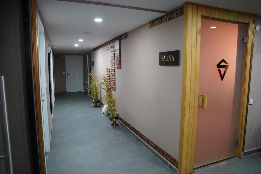 an office hallway with a door with a sign on it at Safir Hotels Silivri in Silivri