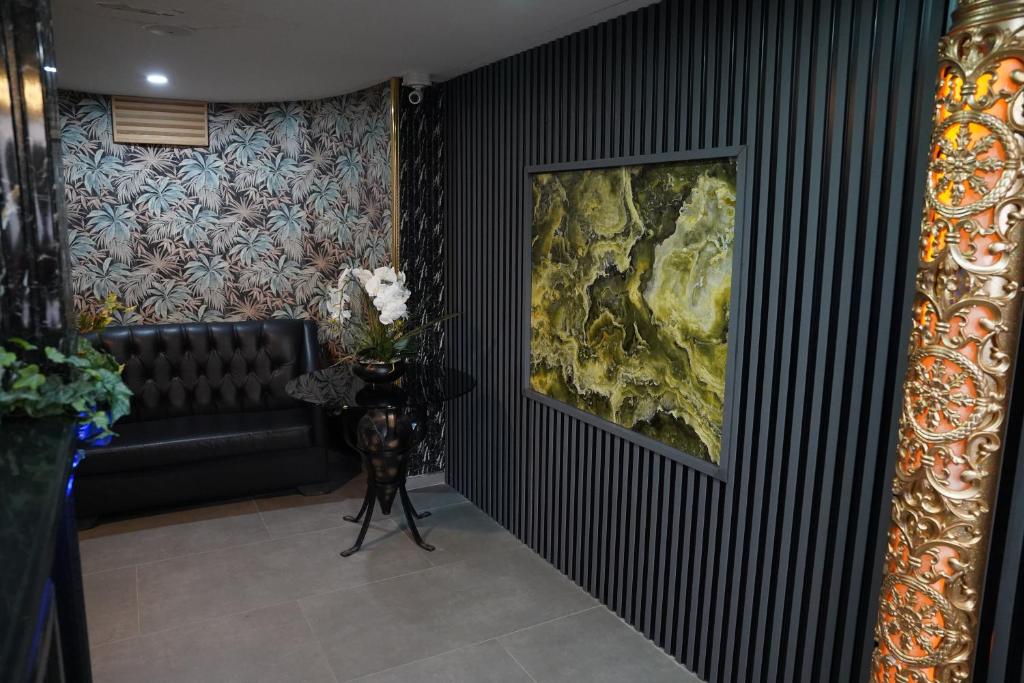 a living room with a couch and a painting on the wall at Safir Hotels Silivri in Silivri
