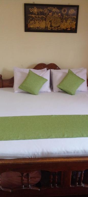 Postel nebo postele na pokoji v ubytování Haranya Homestay
