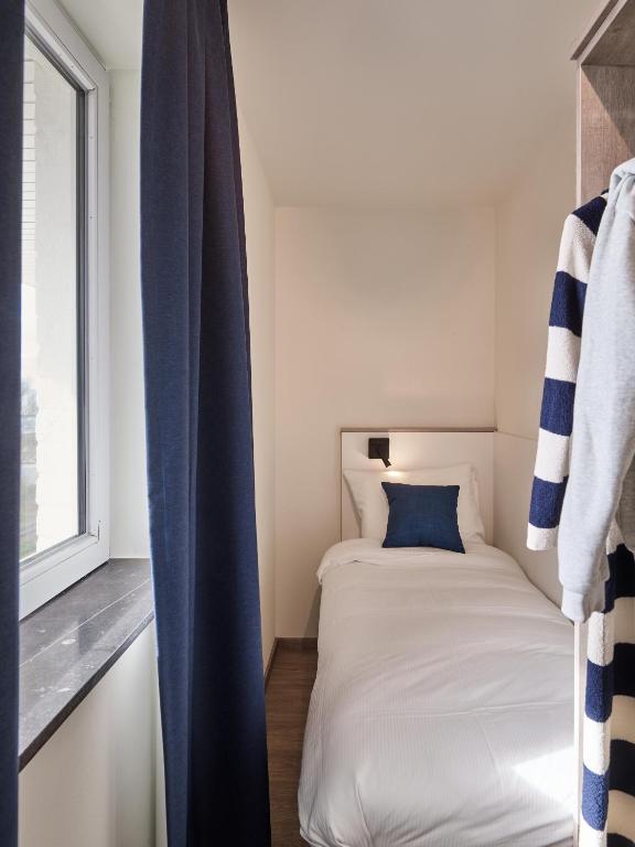 Postel nebo postele na pokoji v ubytování Holiday Suites Zeebrugge