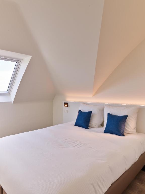 Postel nebo postele na pokoji v ubytování Holiday Suites Zeebrugge