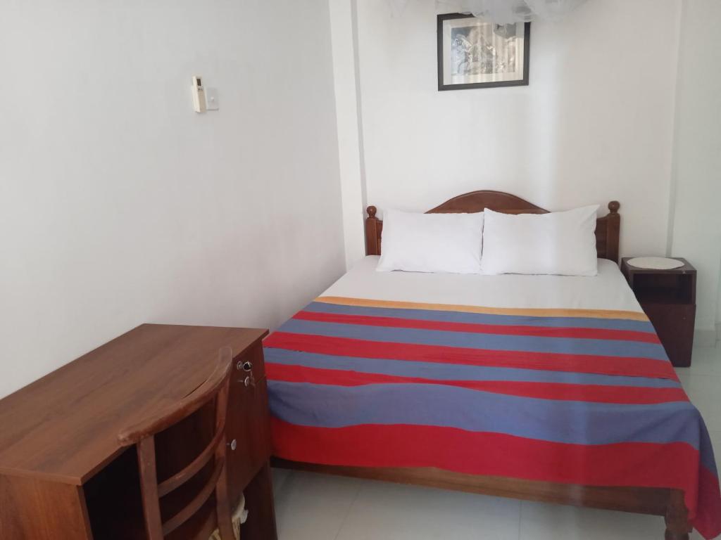 Postel nebo postele na pokoji v ubytování Alex Home Stay