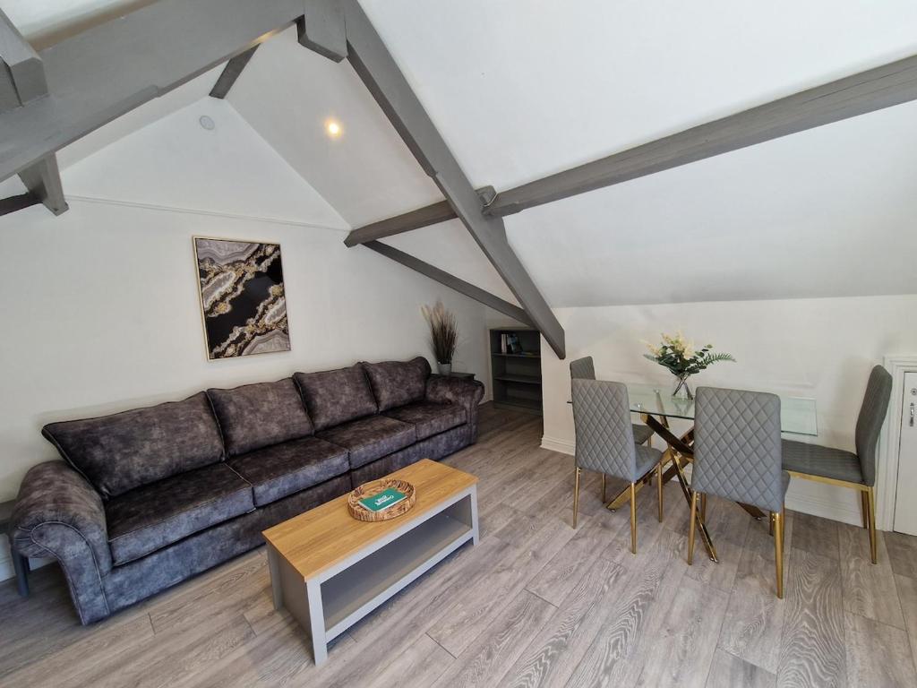 a living room with a couch and a table at Apartment 3 The Baileys Cwm in Cwm
