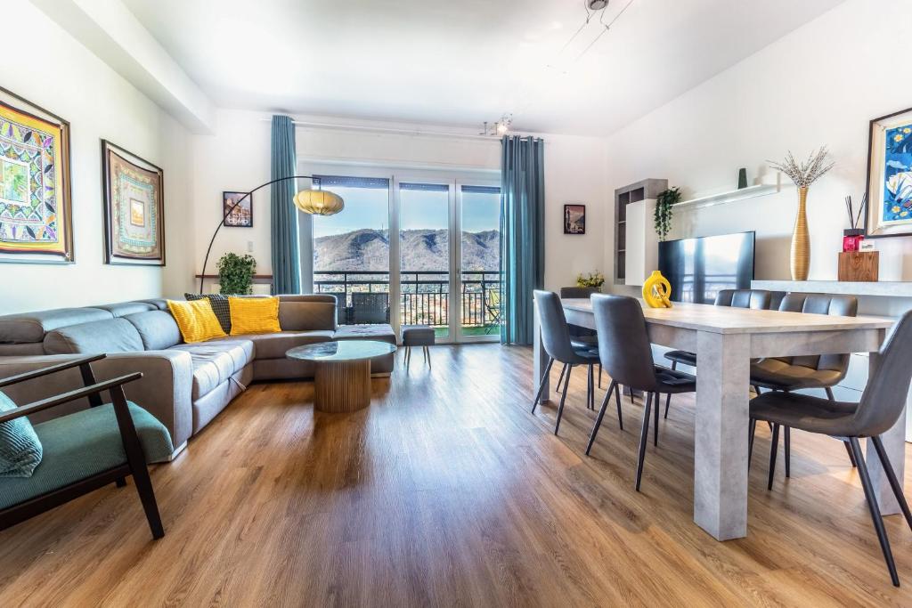 a living room with a couch and a table at Silk & Sunset - City and Lake View with parking in Como