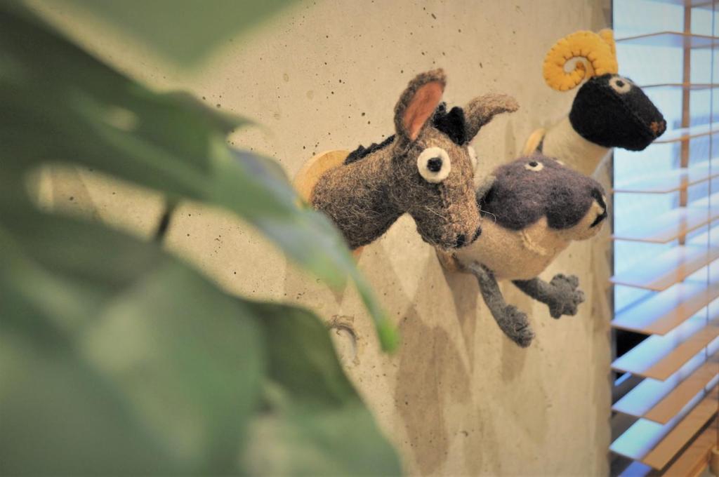 two stuffed animals on the side of a wall at 原田屋Hotel 3F in Tokyo