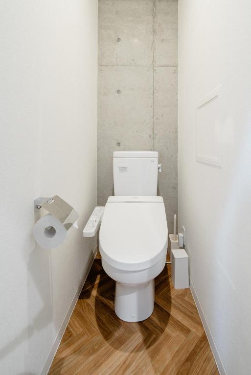 a bathroom with a white toilet in a stall at 原田屋Hotel 3F in Tokyo