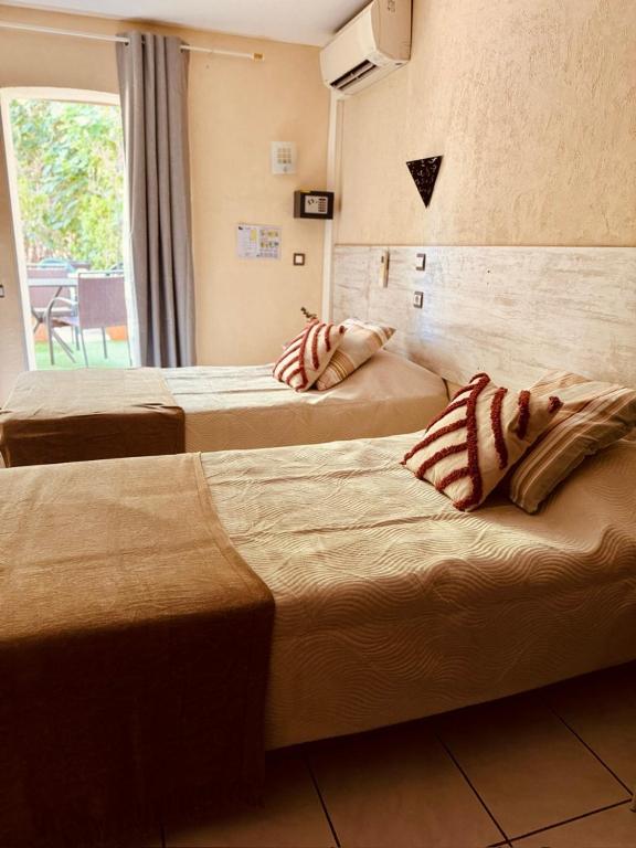Postel nebo postele na pokoji v ubytování Hôtel le Nid
