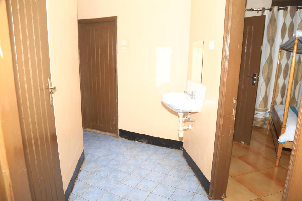 a bathroom with a sink and a mirror at Agenda Namasuba in Kampala