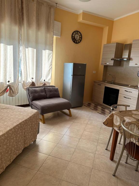 a kitchen with a couch and a refrigerator at La Torretta Sul Porto - Parcheggio gratuito in Livorno