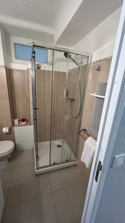 a shower with a glass door in a bathroom at Hotel Miramar- Cap d'Antibes - La Garoupe plage in Antibes