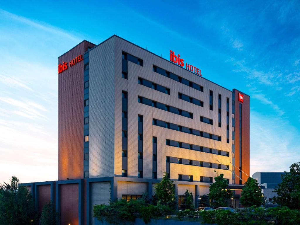a building with a red sign on top of it at ibis Ankara Airport Hotel in Ankara
