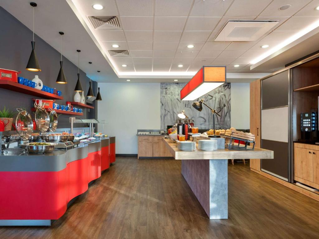 a kitchen with a counter in a restaurant at ibis Ankara Airport Hotel in Ankara