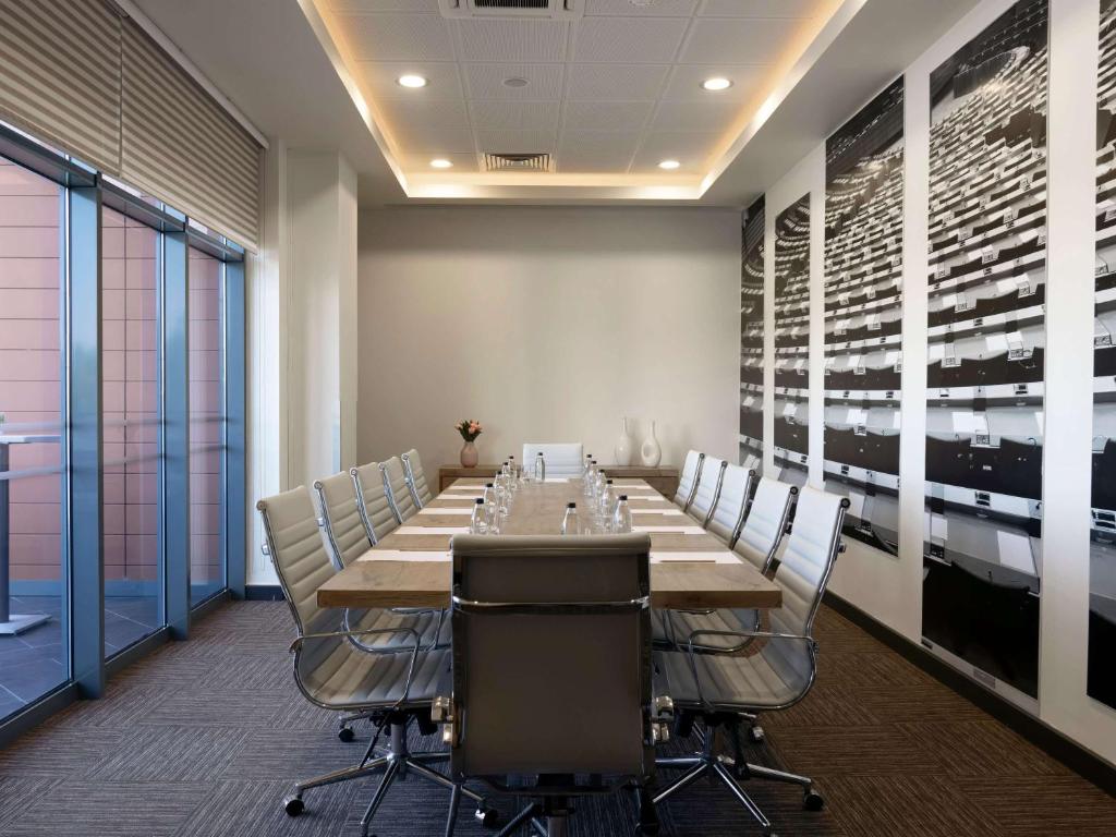 a conference room with a long table and chairs at ibis Ankara Airport Hotel in Ankara