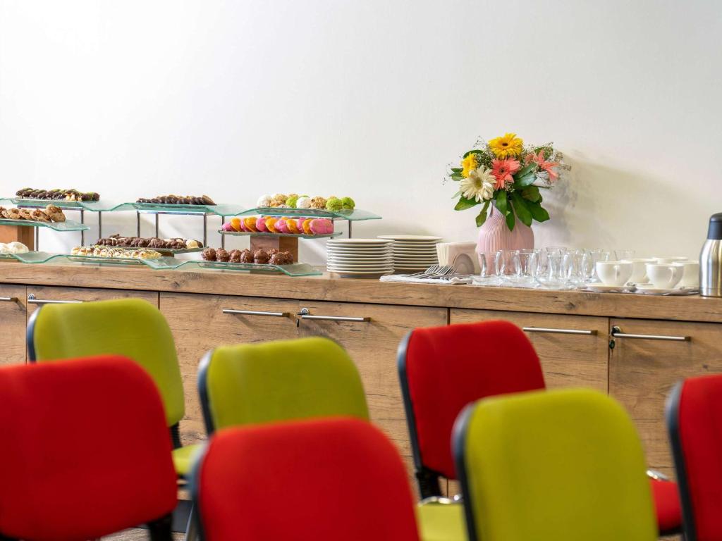 a group of chairs in a room with a buffet at ibis Ankara Airport Hotel in Ankara