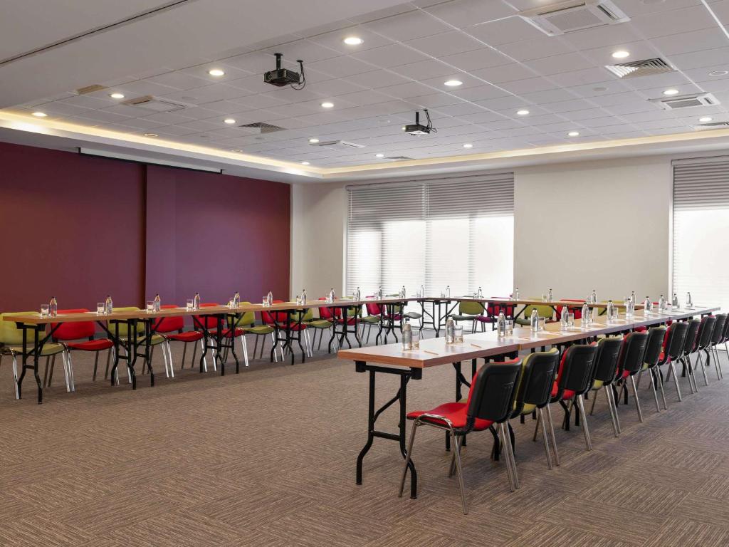 a conference room with a long table and chairs at ibis Ankara Airport Hotel in Ankara