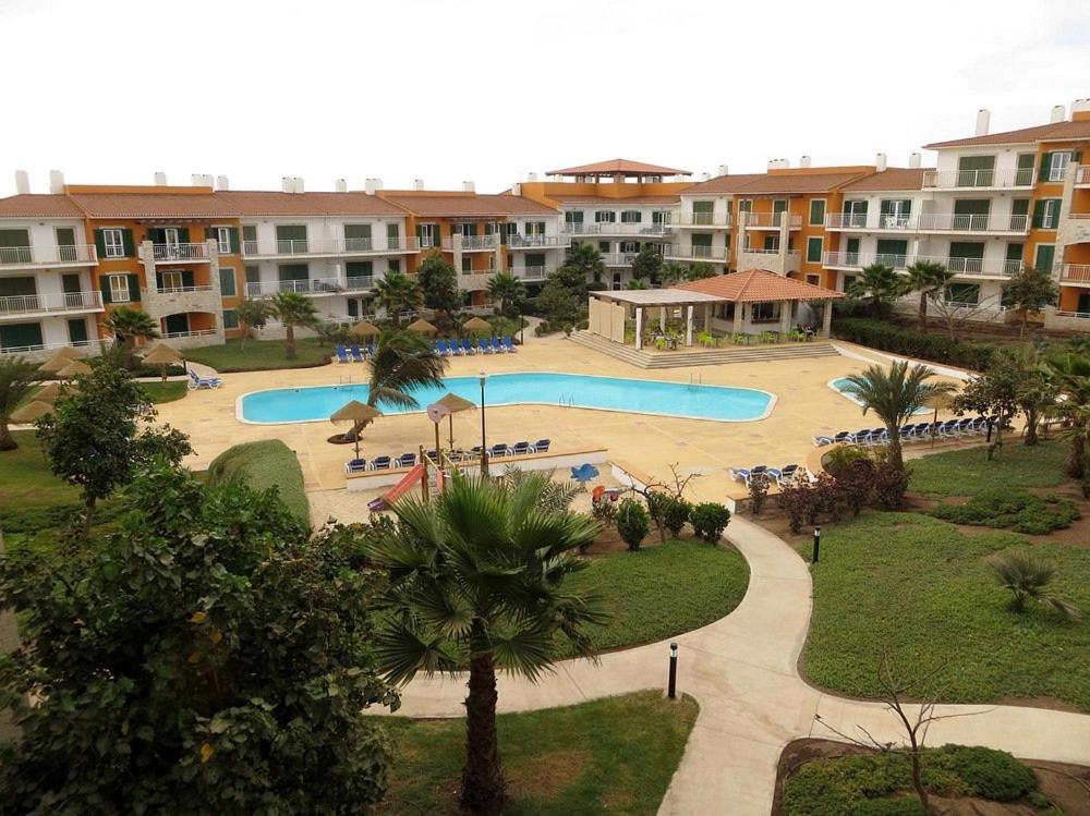 an image of a swimming pool at a resort at condomínio vila verde Pepper T0 e T1 in Santa Maria