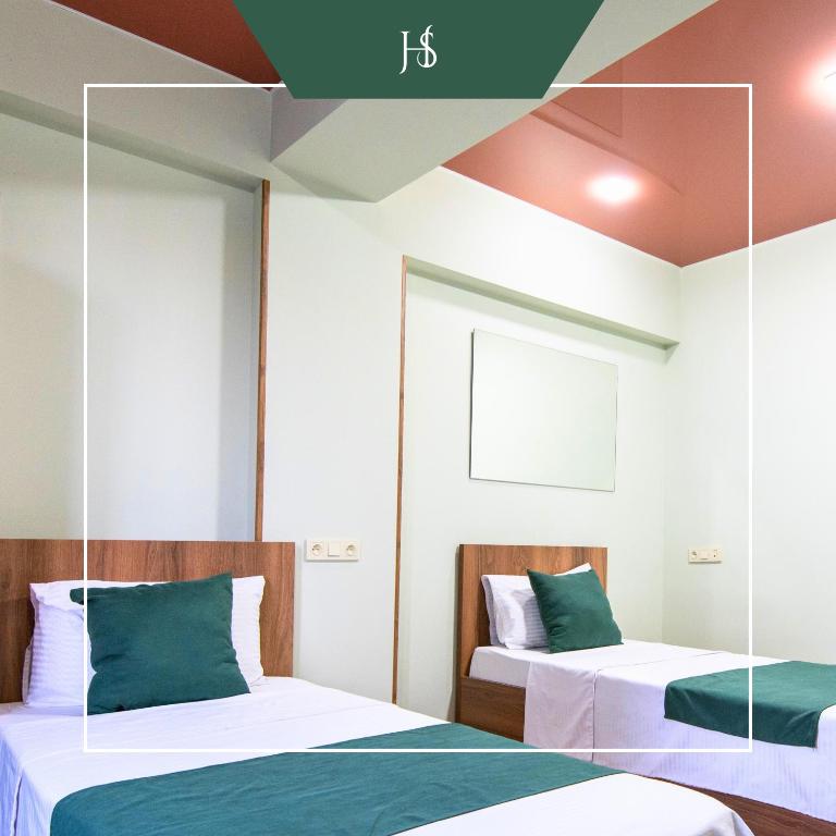 Postel nebo postele na pokoji v ubytování Hotel Serenity