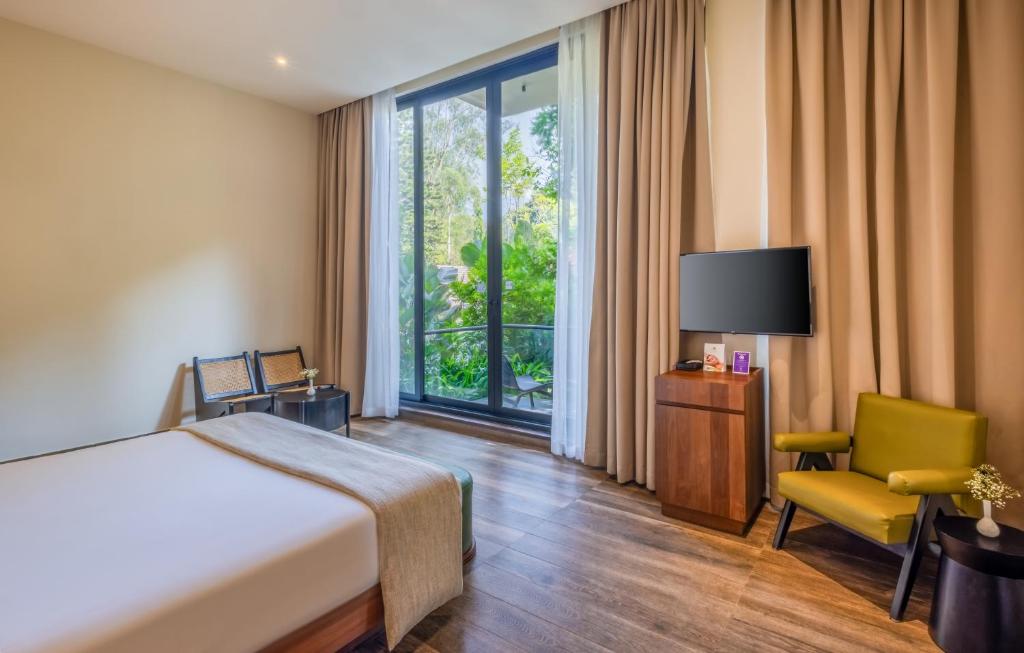 Postel nebo postele na pokoji v ubytování Flora Vythiri Resort