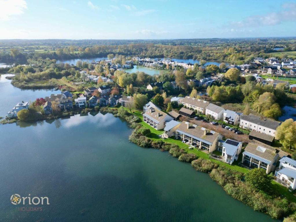 an aerial view of a town next to a river at Clearwater 31, The Lakehouse in Somerford Keynes