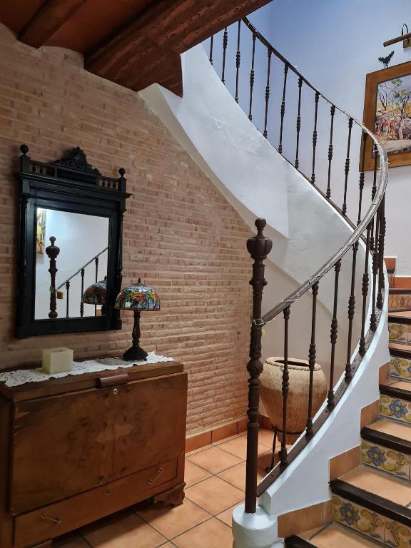 a stairwell with a mirror and a staircase with a stair case at La Moreneta in Casas de Haro