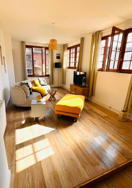 un salon avec un canapé et une télévision dans l'établissement Duplex du Palais, à Douai