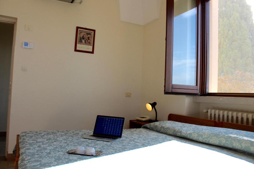 Postel nebo postele na pokoji v ubytování Albergo Del Santuario