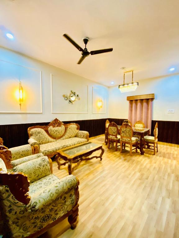 a living room with furniture and a ceiling fan at A Cozy Villa In Rishikesh-The Figtree Inn in Rishīkesh