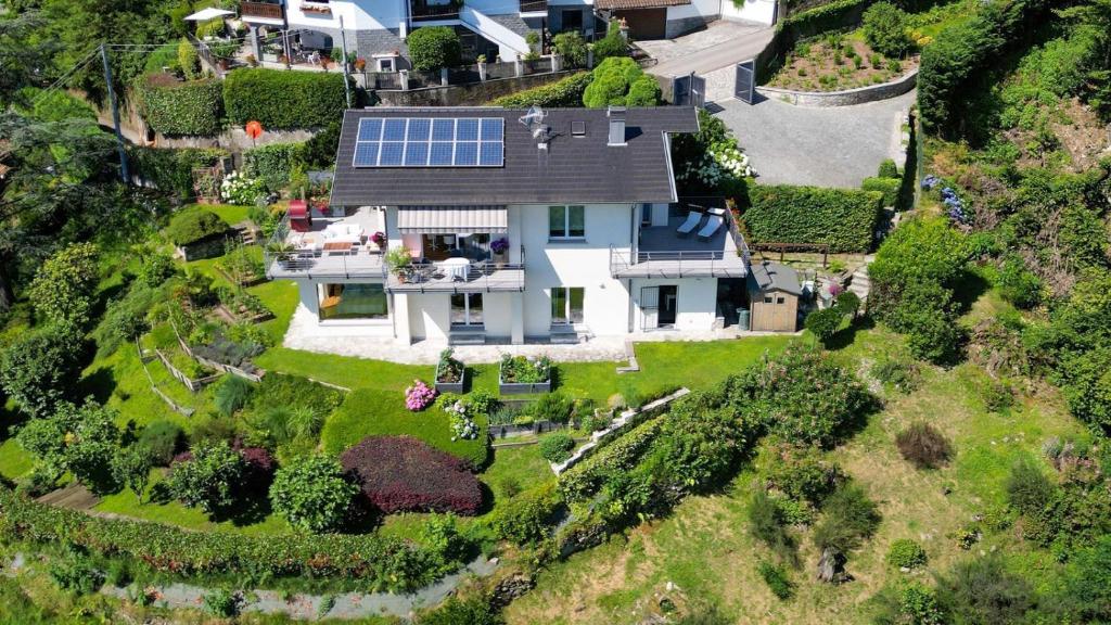 an aerial view of a house with a solarium at Panoramic Design Villa on Lake Maggiore! Villa Sfarzoso in Levo